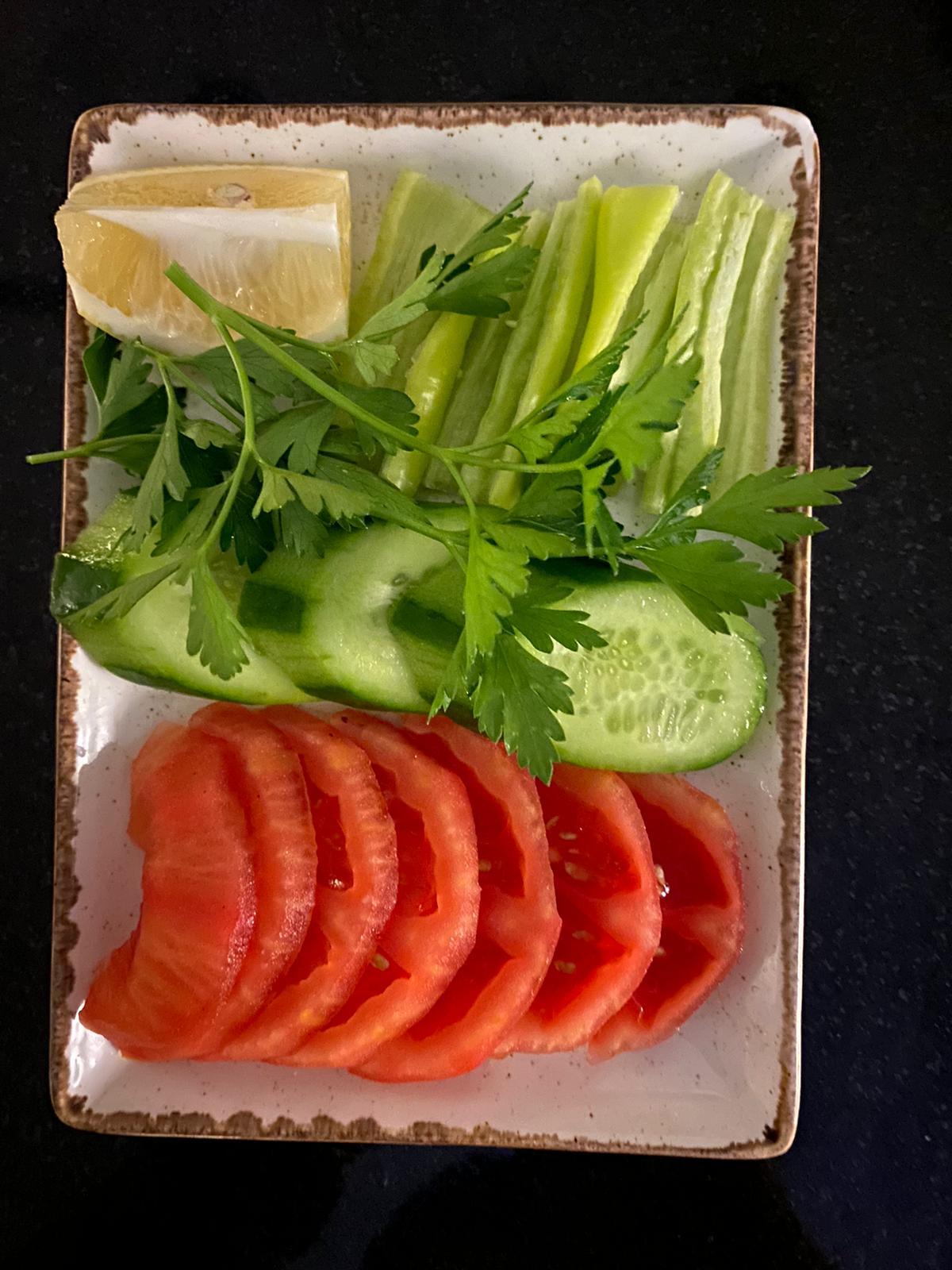 SLICED TOMATO ANT CUCUMBER SERVED WITH NO DRESSING